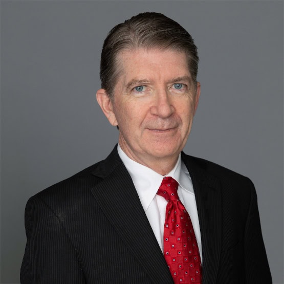 Headshot of David A. Kostick, M.D. in professional wear with a grey background.  