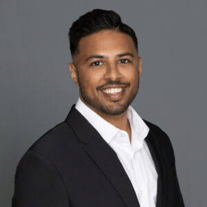 Headshot of Dr. Omar-Gayasaddin in professional wear with a grey background.