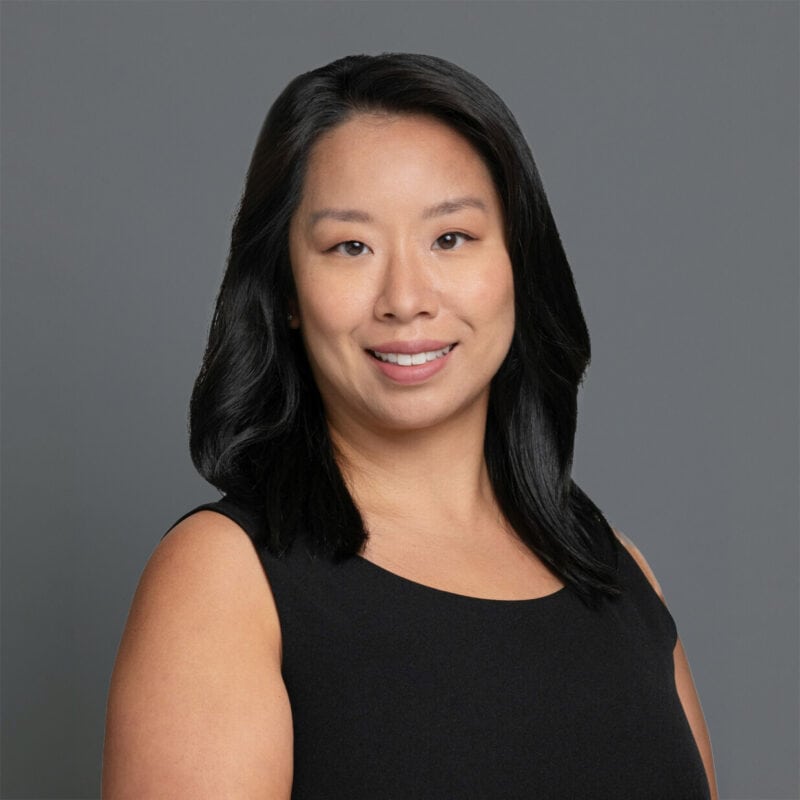 Headshot of Dr. Lawing in professional wear with a grey background.