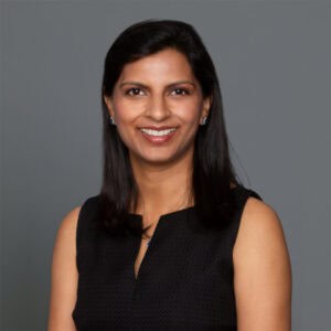 Headshot of Dr. Rachana Patel in professional wear with a grey background.